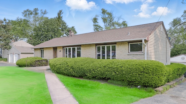 540 W Madison St, Lombard, IL 60148 - view of front facade featuring a chimney, a garage, brick siding, a shingled roof, and a front lawn
