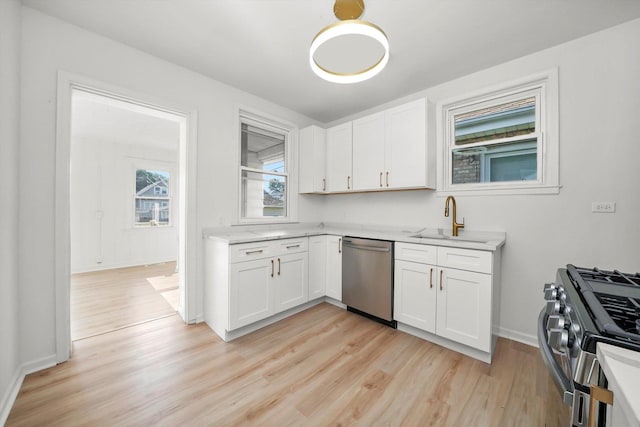 3633 N Lotus Ave, Chicago, IL 60641 - kitchen with stainless steel appliances, light wood-type flooring, light countertops, and white cabinetry