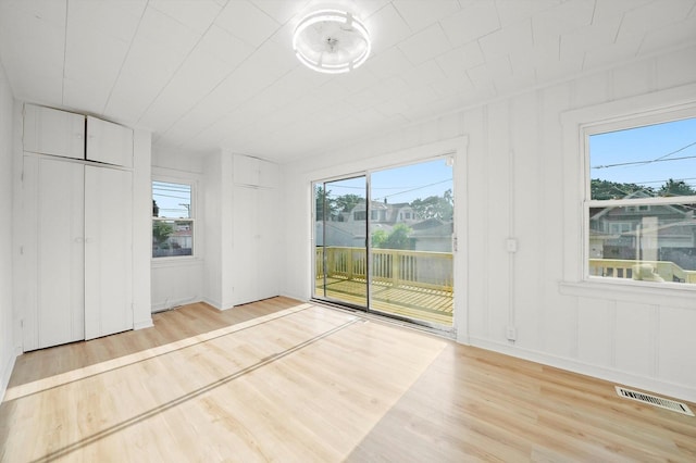 3633 N Lotus Ave, Chicago, IL 60641 - unfurnished bedroom with access to outside, wood finished floors, and multiple windows
