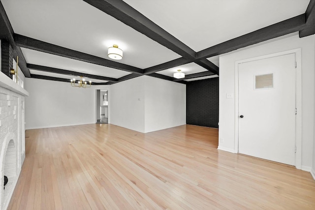 3633 N Lotus Ave, Chicago, IL 60641 - unfurnished living room with a chandelier, light wood finished floors, beam ceiling, a brick fireplace, and brick wall