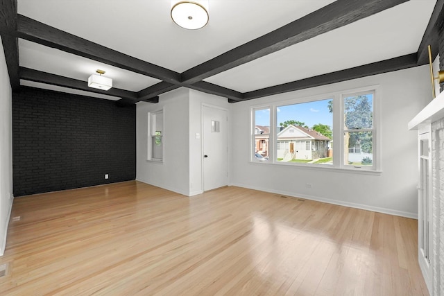 3633 N Lotus Ave, Chicago, IL 60641 - unfurnished living room featuring light wood-style flooring, beamed ceiling, and brick wall