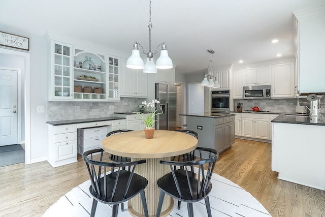 26W231 Tuckaway Ct, Winfield, IL 60190 - kitchen featuring stainless steel appliances, dark countertops, decorative backsplash, white cabinets, and recessed lighting