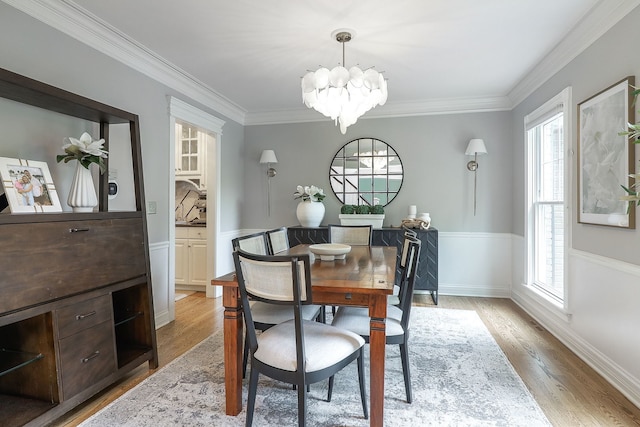 26W231 Tuckaway Ct, Winfield, IL 60190 - dining area featuring a chandelier, plenty of natural light, light wood-type flooring, ornamental molding, and wainscoting