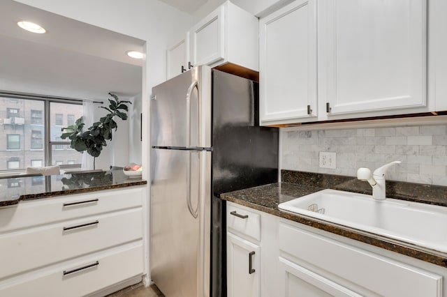 1550 N Lake Shore Dr Unit 9F, Chicago, IL 60610 - kitchen featuring freestanding refrigerator, a sink, white cabinets, tasteful backsplash, and dark stone counters