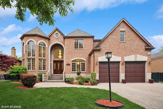 3832 W Chase Ave, Lincolnwood, IL 60712 - view of front of home featuring brick siding, a front yard, and decorative driveway