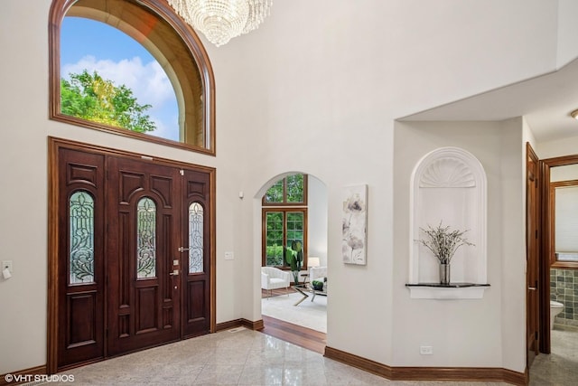 3832 W Chase Ave, Lincolnwood, IL 60712 - foyer entrance with a chandelier, a towering ceiling, and granite floors