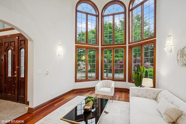 3832 W Chase Ave, Lincolnwood, IL 60712 - living area with a high ceiling, arched walkways, and wood finished floors