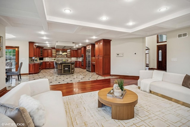 3832 W Chase Ave, Lincolnwood, IL 60712 - living room featuring coffered ceiling, light wood-style floors, arched walkways, beam ceiling, and recessed lighting