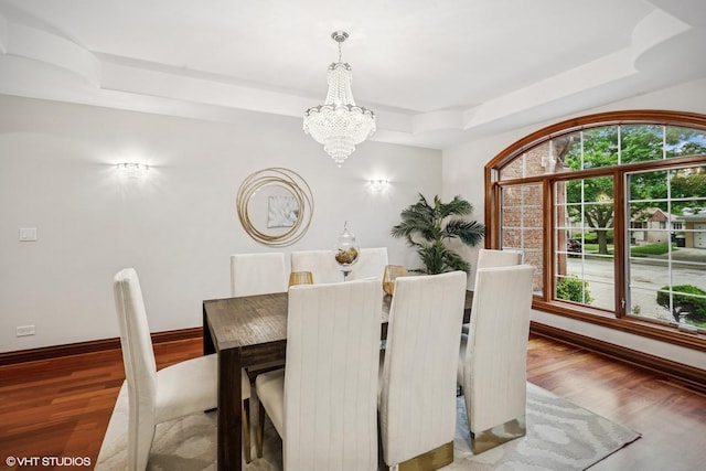 3832 W Chase Ave, Lincolnwood, IL 60712 - dining area featuring a tray ceiling, a chandelier, and wood finished floors