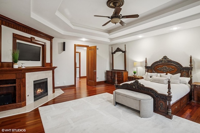 3832 W Chase Ave, Lincolnwood, IL 60712 - bedroom with a raised ceiling, wood finished floors, a fireplace, recessed lighting, and ceiling fan
