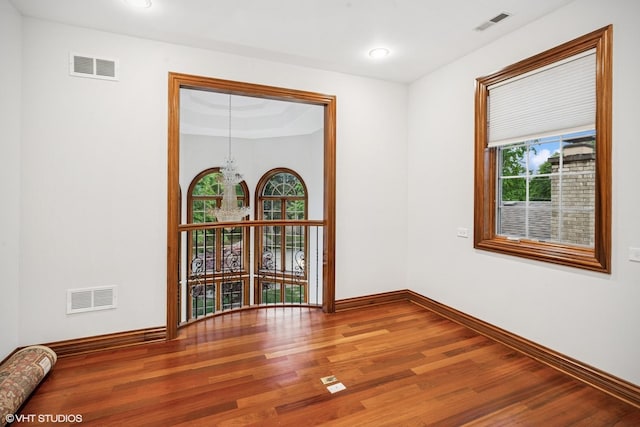 3832 W Chase Ave, Lincolnwood, IL 60712 - spare room featuring wood finished floors and a chandelier