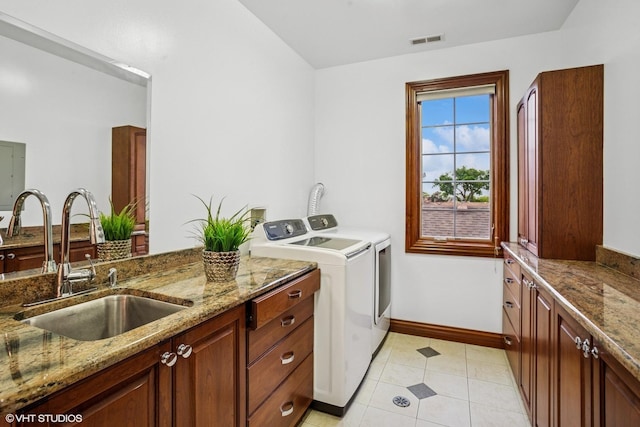 3832 W Chase Ave, Lincolnwood, IL 60712 - washroom featuring separate washer and dryer, light tile patterned floors, and cabinet space