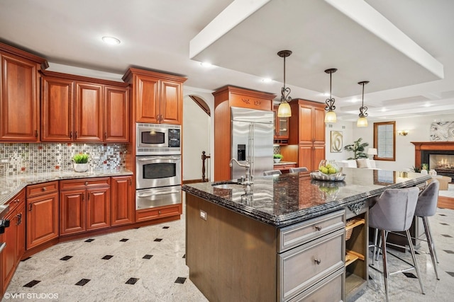 3832 W Chase Ave, Lincolnwood, IL 60712 - kitchen featuring built in appliances, a warming drawer, a kitchen bar, dark stone countertops, and backsplash