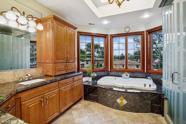 3832 W Chase Ave, Lincolnwood, IL 60712 - full bathroom featuring plenty of natural light, a jetted tub, vanity, and backsplash