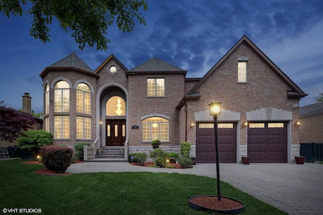 3832 W Chase Ave, Lincolnwood, IL 60712 - french country inspired facade with brick siding, decorative driveway, and a front yard