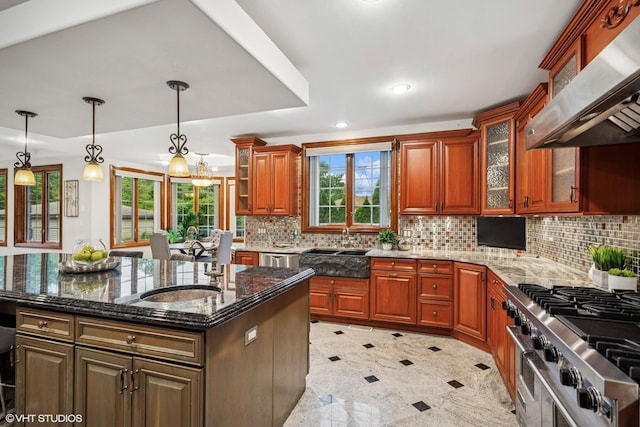 3832 W Chase Ave, Lincolnwood, IL 60712 - kitchen featuring wall chimney exhaust hood, dark stone countertops, tasteful backsplash, an island with sink, and recessed lighting