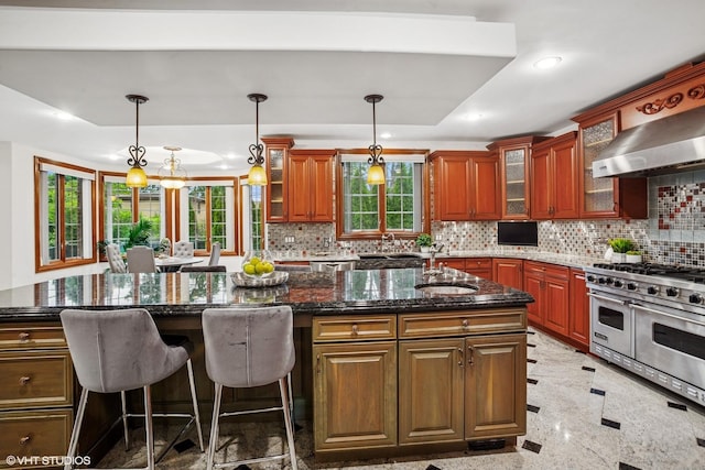 3832 W Chase Ave, Lincolnwood, IL 60712 - kitchen featuring double oven range, recessed lighting, wall chimney exhaust hood, a center island, and decorative backsplash