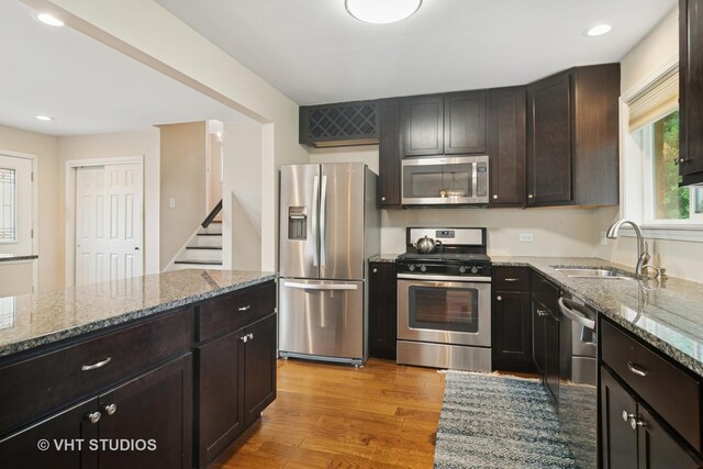 354 W Pleasant Hill Blvd, Palatine, IL 60067 - kitchen with appliances with stainless steel finishes, stone countertops, light wood-style flooring, dark brown cabinetry, and recessed lighting