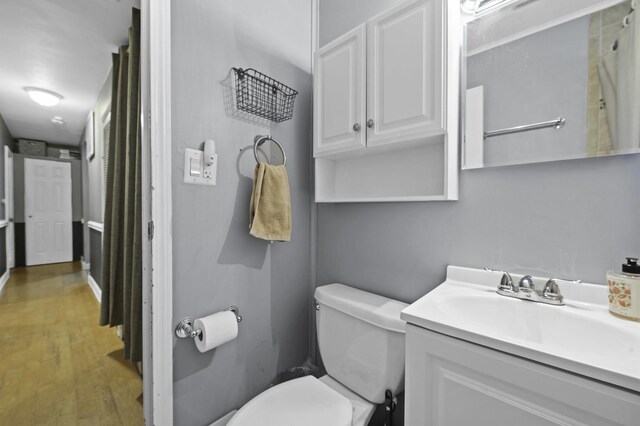 215 Cypress Dr, Streamwood, IL 60107 - bathroom featuring vanity, toilet, and wood finished floors