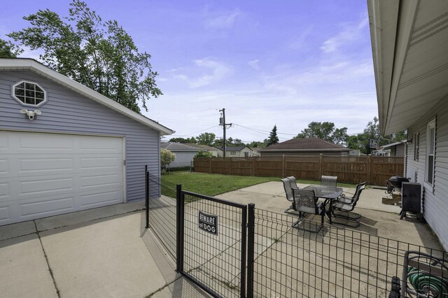 215 Cypress Dr, Streamwood, IL 60107 - view of patio / terrace featuring concrete driveway, outdoor dining area, and an outbuilding