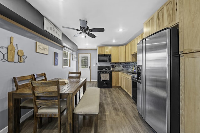 215 Cypress Dr, Streamwood, IL 60107 - kitchen with black appliances, light brown cabinetry, ceiling fan, dark wood-style floors, and decorative backsplash