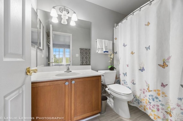 2402 Oakfield Ct, Aurora, IL 60503 - full bath featuring toilet, vanity, wood finished floors, a chandelier, and a shower with curtain