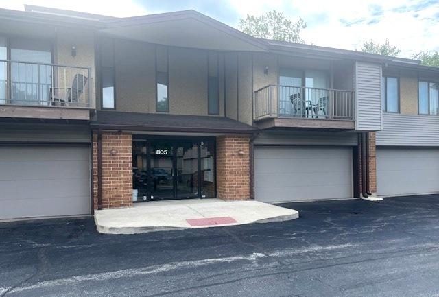 805 Oakton St Unit 103, Elk Grove Village, IL 60007 - multi unit property featuring brick siding, an attached garage, and a balcony