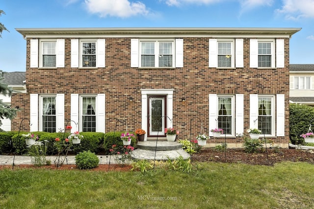 3835 Huntington Blvd, Hoffman Estates, IL 60192 - colonial home featuring brick siding and a front lawn
