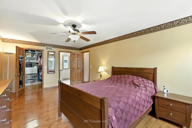 3835 Huntington Blvd, Hoffman Estates, IL 60192 - bedroom featuring light wood-type flooring, a closet, a spacious closet, and a ceiling fan
