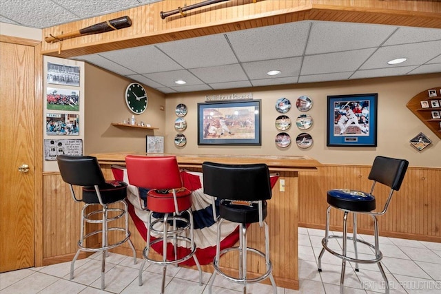 2937 Arbor Ln, Aurora, IL 60502 - indoor dry bar featuring a paneled ceiling, light tile patterned floors, wainscoting, wood walls, and recessed lighting