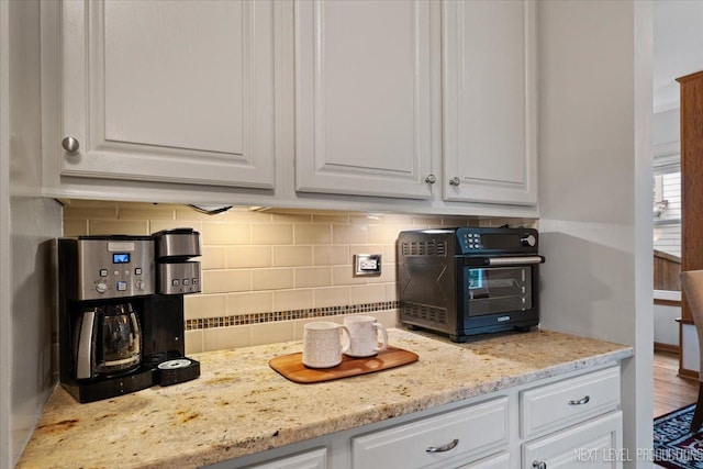 2937 Arbor Ln, Aurora, IL 60502 - kitchen with white cabinetry, backsplash, and light stone countertops