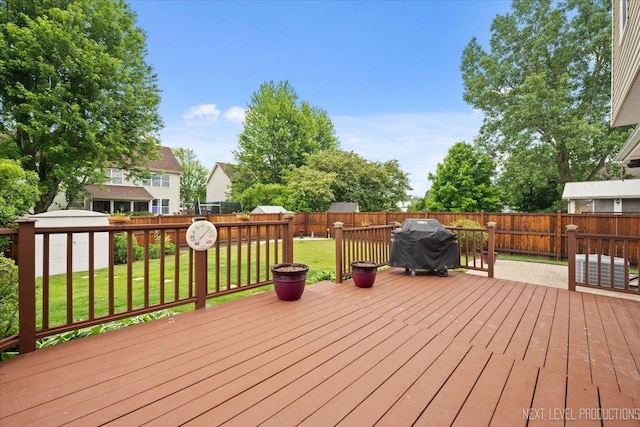 2937 Arbor Ln, Aurora, IL 60502 - wooden terrace featuring a fenced backyard, a storage shed, and area for grilling