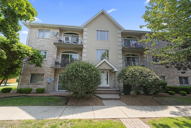 9431 S 79th Ave Unit 105N, Hickory Hills, IL 60457 - townhome / multi-family property with brick siding, a balcony, and stucco siding