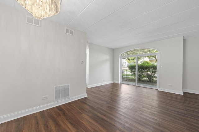 9431 S 79th Ave Unit 105N, Hickory Hills, IL 60457 - unfurnished room with a chandelier, dark wood-type flooring, baseboards, and a textured ceiling
