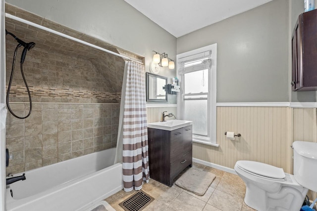 952 Larkin Ave, Elgin, IL 60123 - bathroom featuring vanity, shower / bath combination with curtain, a wainscoted wall, and tile patterned floors