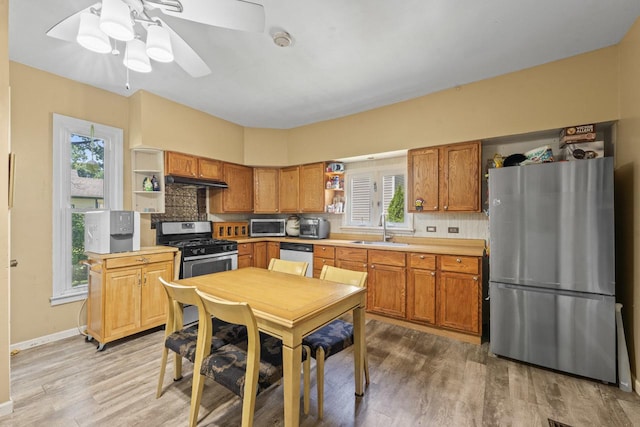 952 Larkin Ave, Elgin, IL 60123 - kitchen featuring stainless steel appliances, open shelves, light wood finished floors, decorative backsplash, and ceiling fan