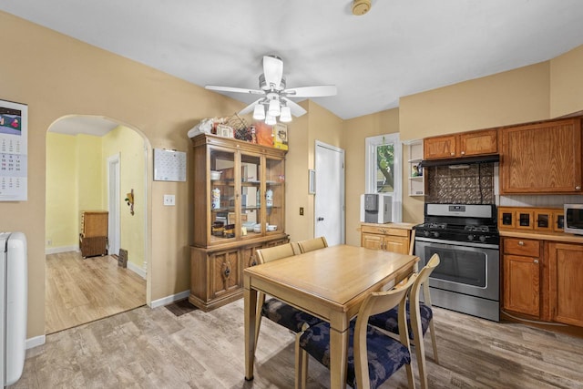 952 Larkin Ave, Elgin, IL 60123 - dining area featuring light wood-type flooring, arched walkways, and a ceiling fan