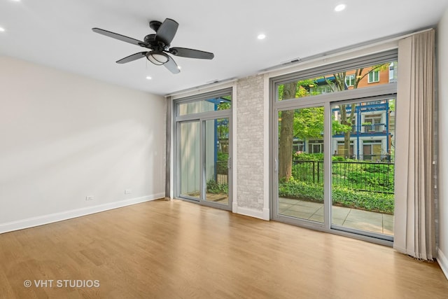 23 N Racine Ave Unit 405, Chicago, IL 60607 - unfurnished room with wood finished floors, recessed lighting, a ceiling fan, and brick wall