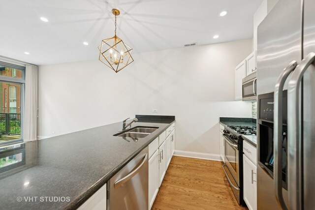 23 N Racine Ave Unit 405, Chicago, IL 60607 - kitchen featuring appliances with stainless steel finishes, dark countertops, white cabinets, hanging light fixtures, and recessed lighting