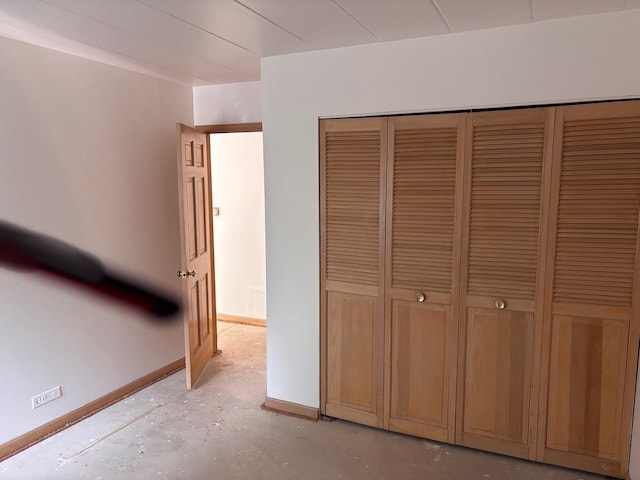 1015 Deerfield Rd Unit 132, Deerfield, IL 60015 - unfurnished bedroom featuring concrete floors and a closet