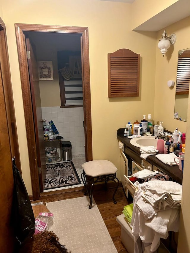 bathroom with wood finished floors and vanity