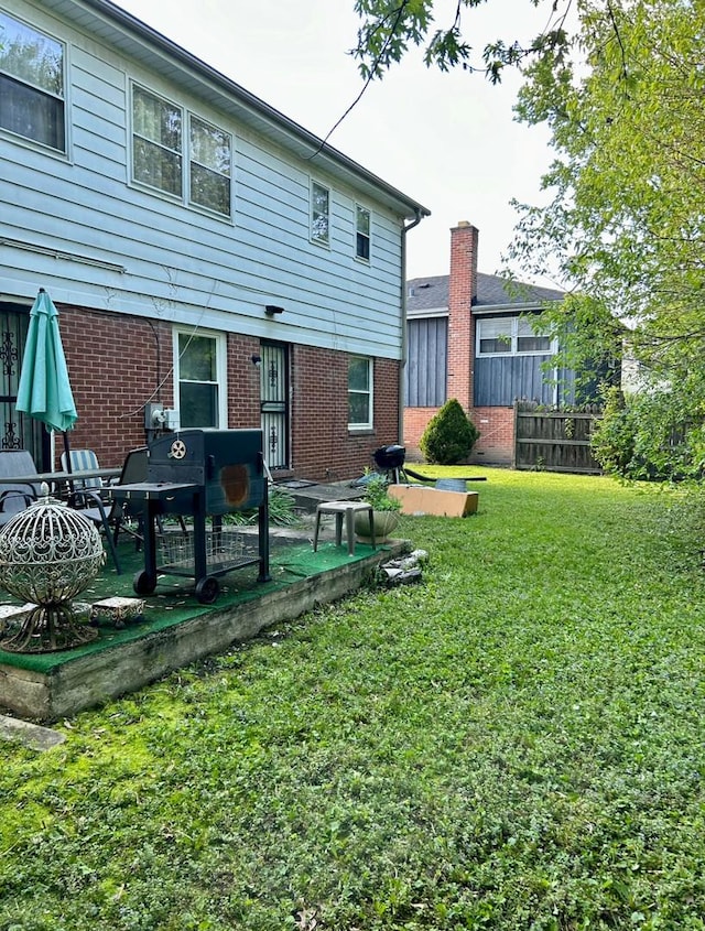 back of property with brick siding and a patio area