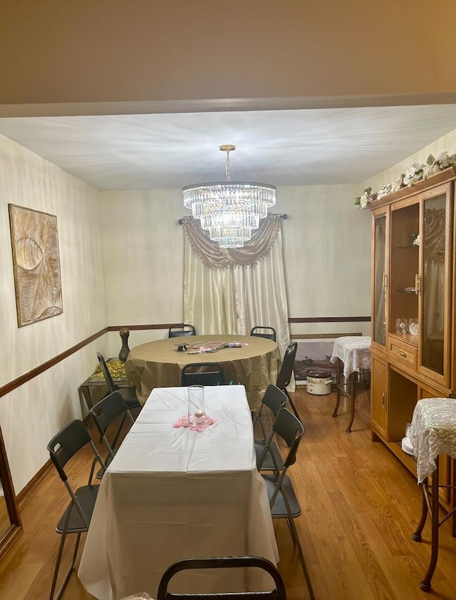 dining space featuring a chandelier and wood finished floors