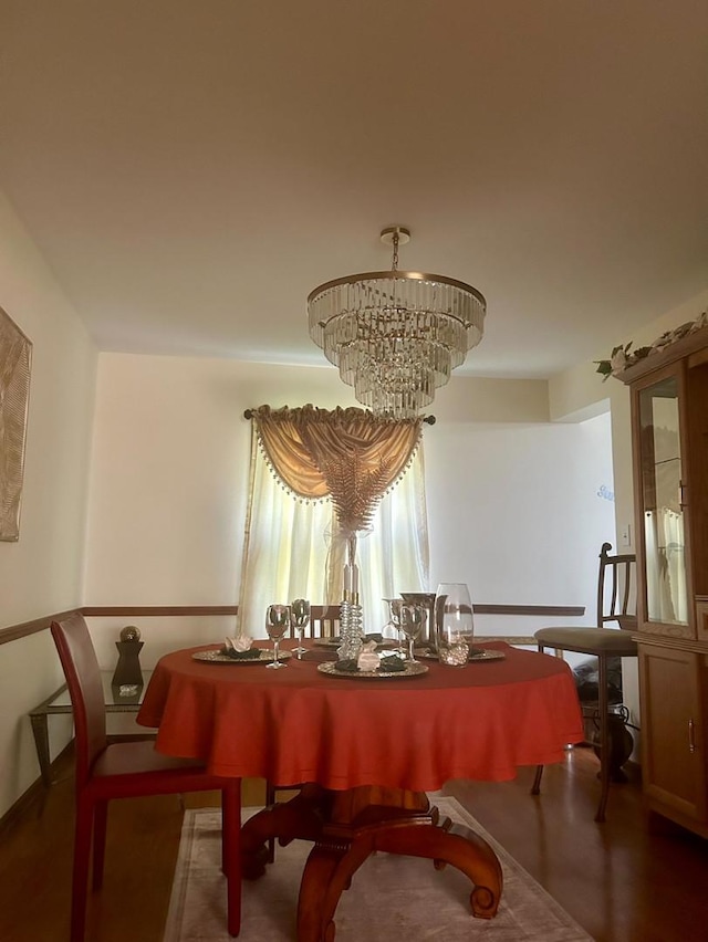 dining room with a chandelier and wood finished floors