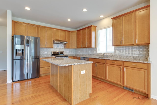 3452 Birch Ln, Naperville, IL 60564 - kitchen with appliances with stainless steel finishes, under cabinet range hood, light wood-style floors, backsplash, and a sink