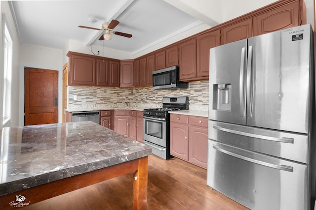 5719 S Spaulding Ave, Chicago, IL 60629 - kitchen with appliances with stainless steel finishes, ceiling fan, light wood finished floors, decorative backsplash, and stone countertops