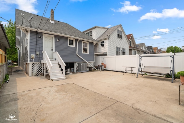 5719 S Spaulding Ave, Chicago, IL 60629 - rear view of property with a patio, a chimney, central AC, and roof with shingles