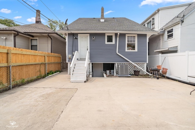 5719 S Spaulding Ave, Chicago, IL 60629 - rear view of house featuring a fenced backyard, roof with shingles, and a patio