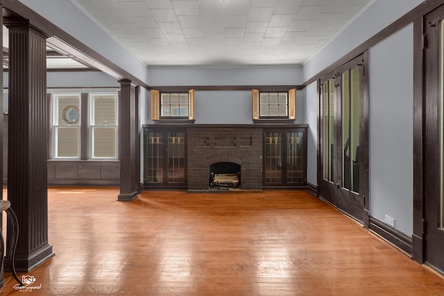 5719 S Spaulding Ave, Chicago, IL 60629 - unfurnished living room featuring ornate columns, wood finished floors, ornamental molding, and a fireplace