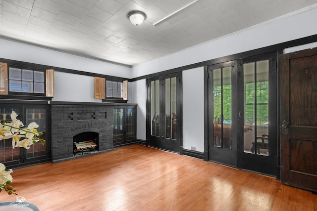 5719 S Spaulding Ave, Chicago, IL 60629 - unfurnished living room featuring wood finished floors, a brick fireplace, and crown molding